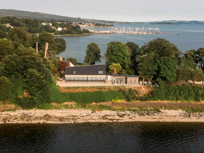 View of Ferry Point House offering serene Loch Lomond accommodation amidst breathtaking Scottish landscapes